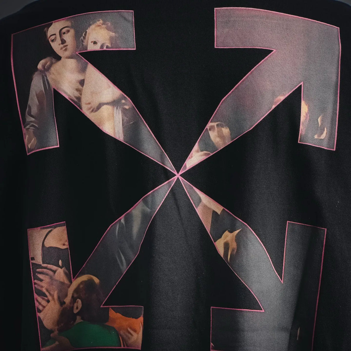 Black T-shirt back with oversized pink outlined arrow-style graphic print