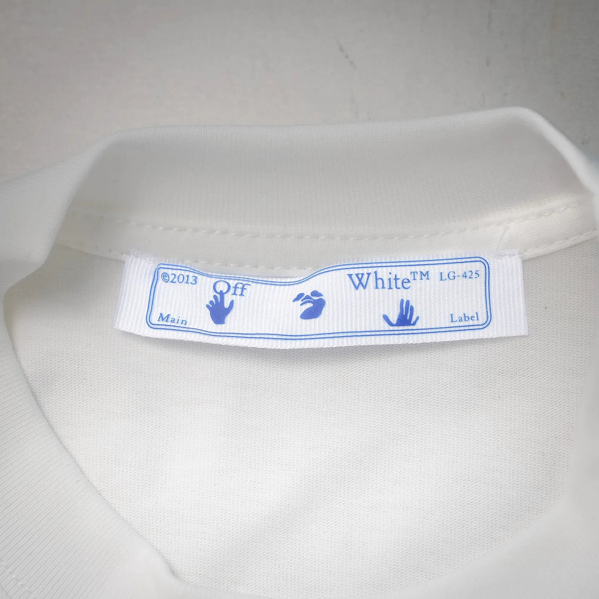 Off-White white T-shirt neck label with blue text and care details