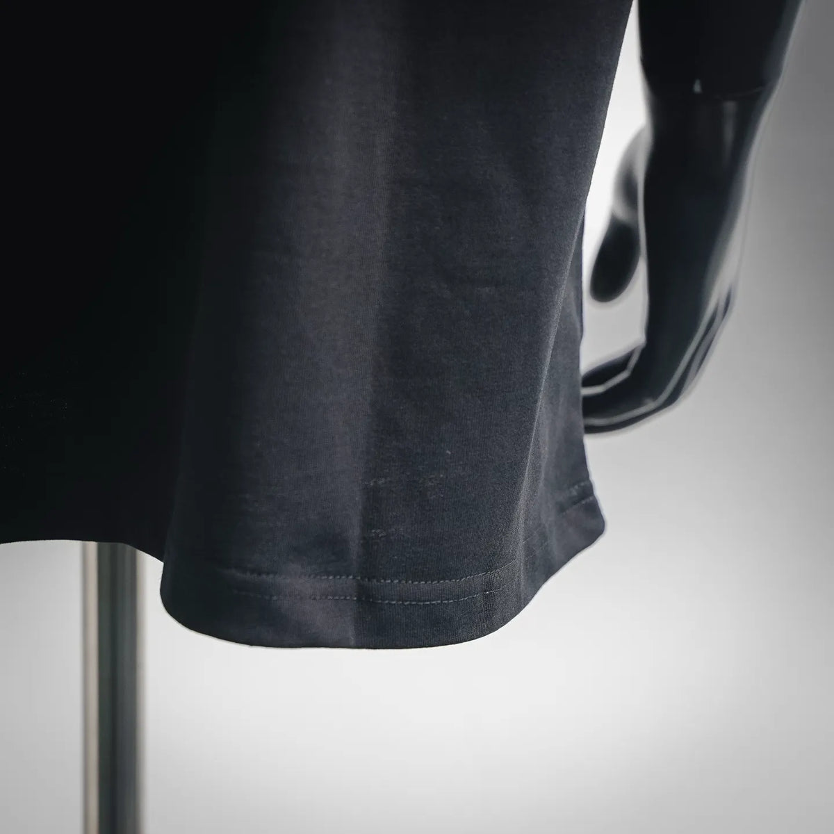 Black short-sleeve T-shirt hem with neat double stitching