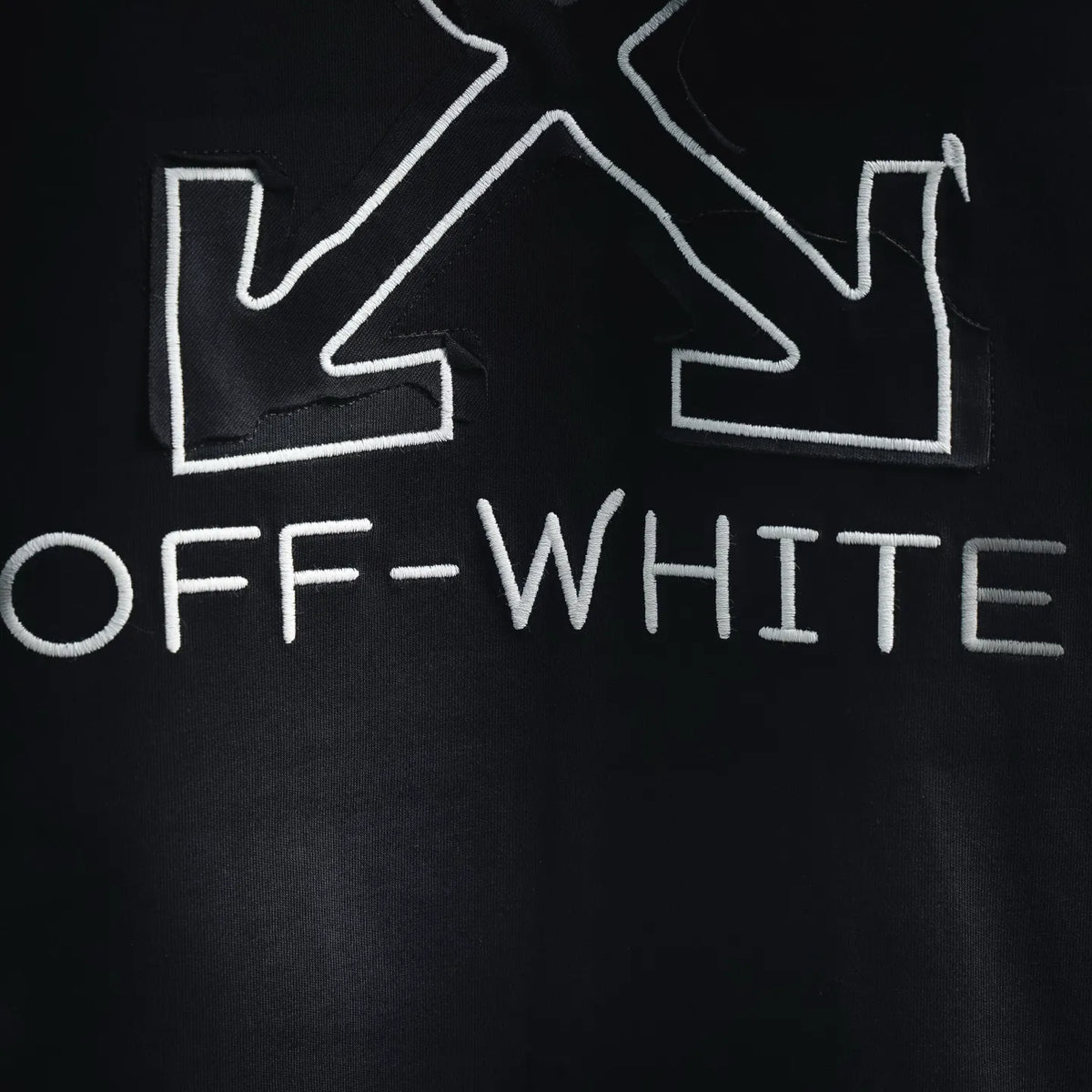 Off-White back text OFF-WHITE below crossed arrow-style graphic