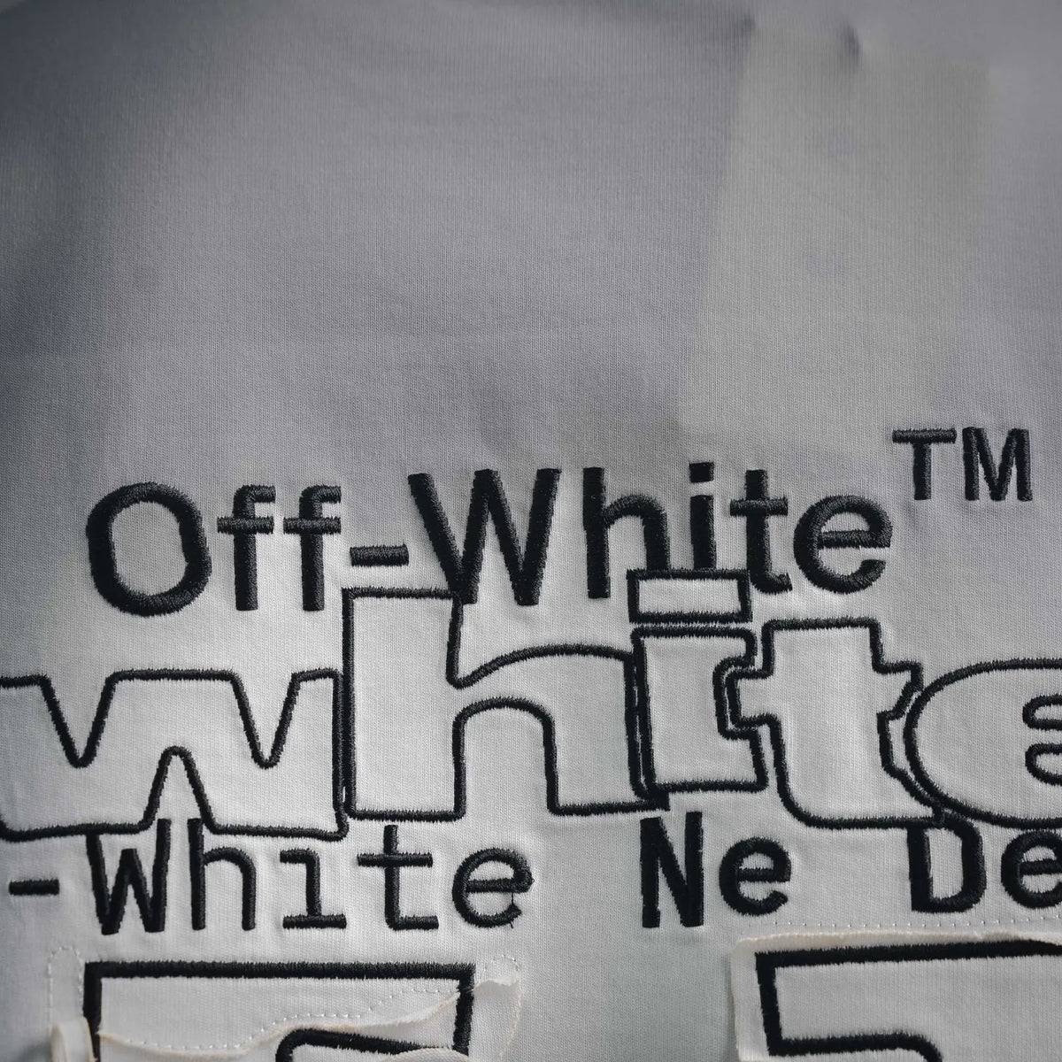 Off-White logo text and graphic print on off-white crewneck T-shirt