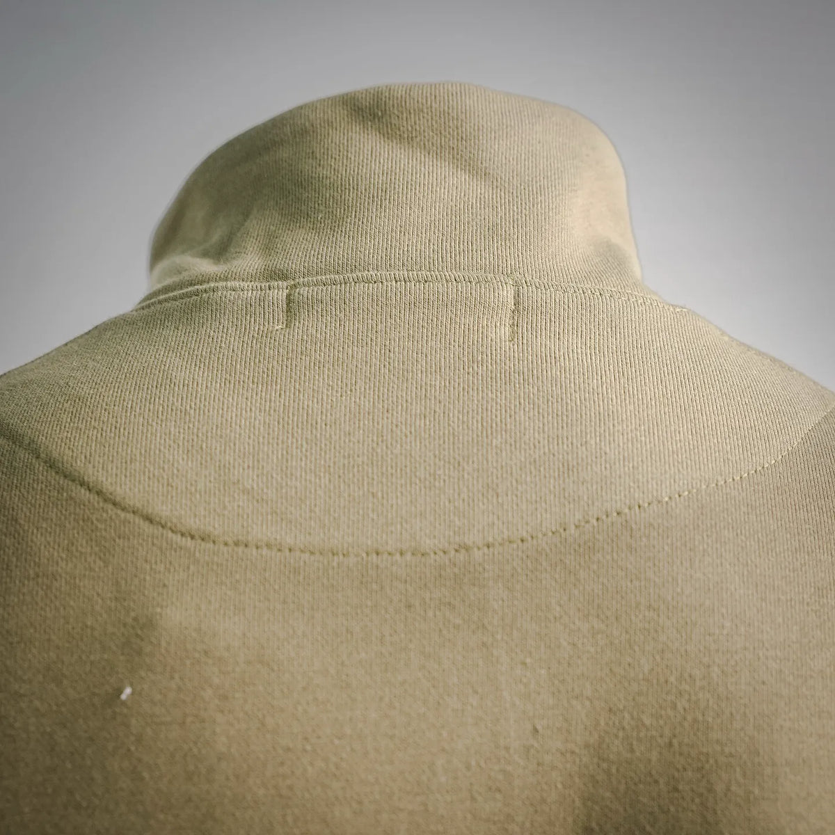 Olive sweatshirt knit high collar with visible seam detail