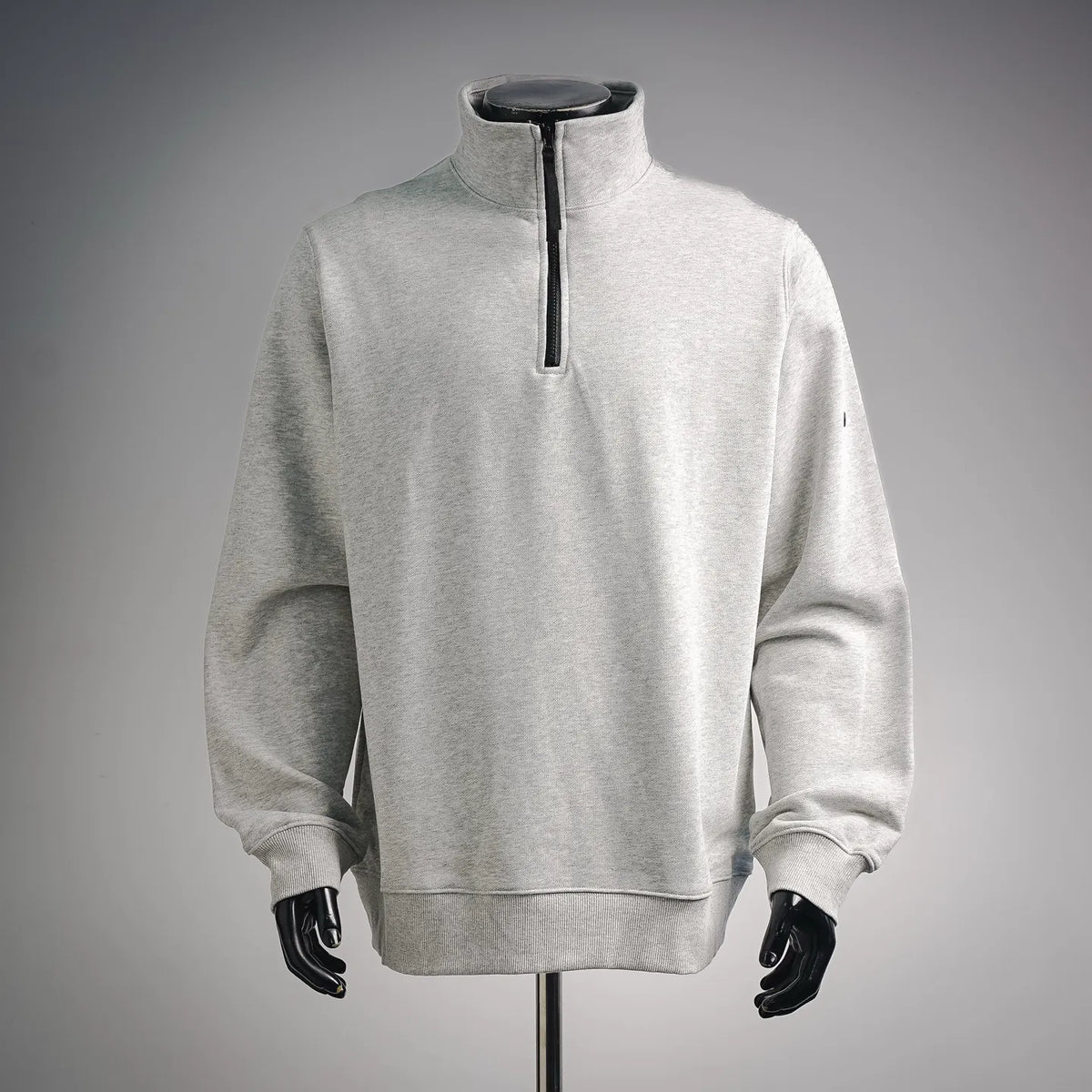 Light gray quarter-zip sweatshirt with stand collar and black zipper placket