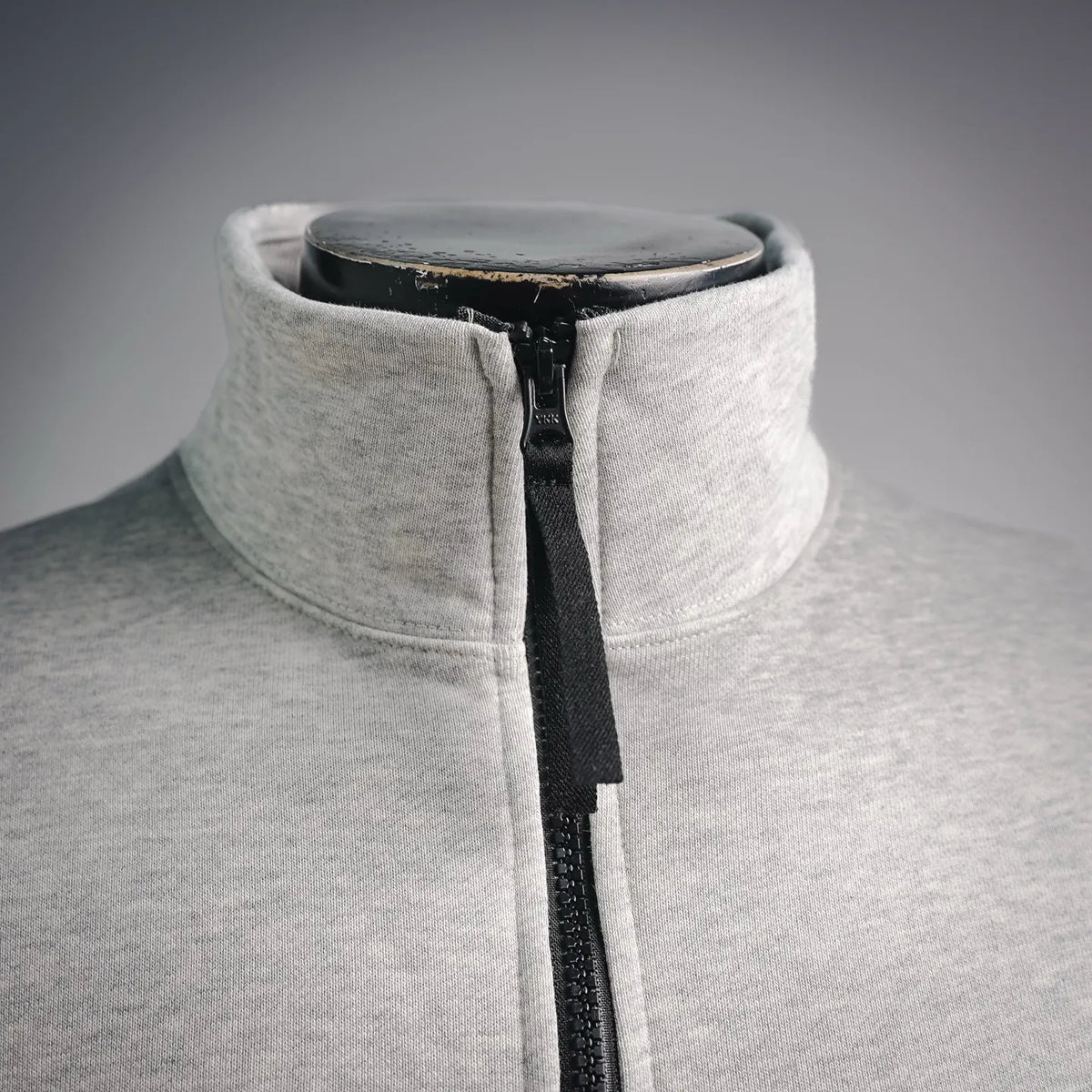 Light gray stand-collar sweatshirt with black quarter-zip front detail