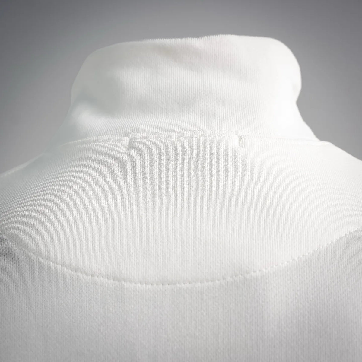 White ribbed mock neck sweatshirt with clean collar seam and knit texture