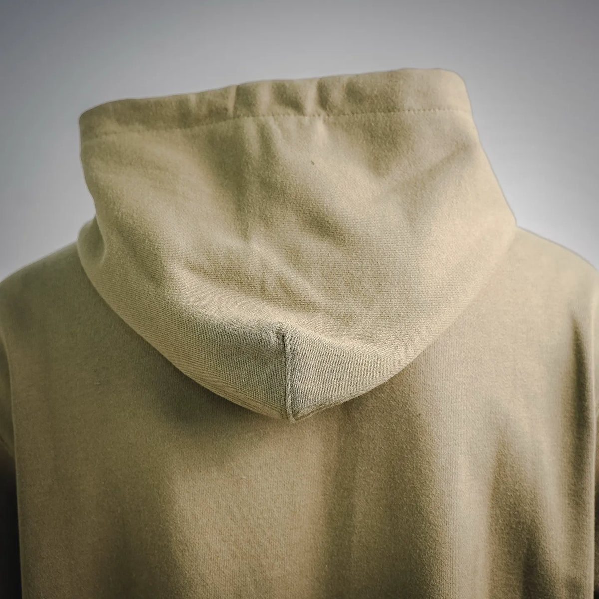 Olive hoodie rear view with hood and side seams
