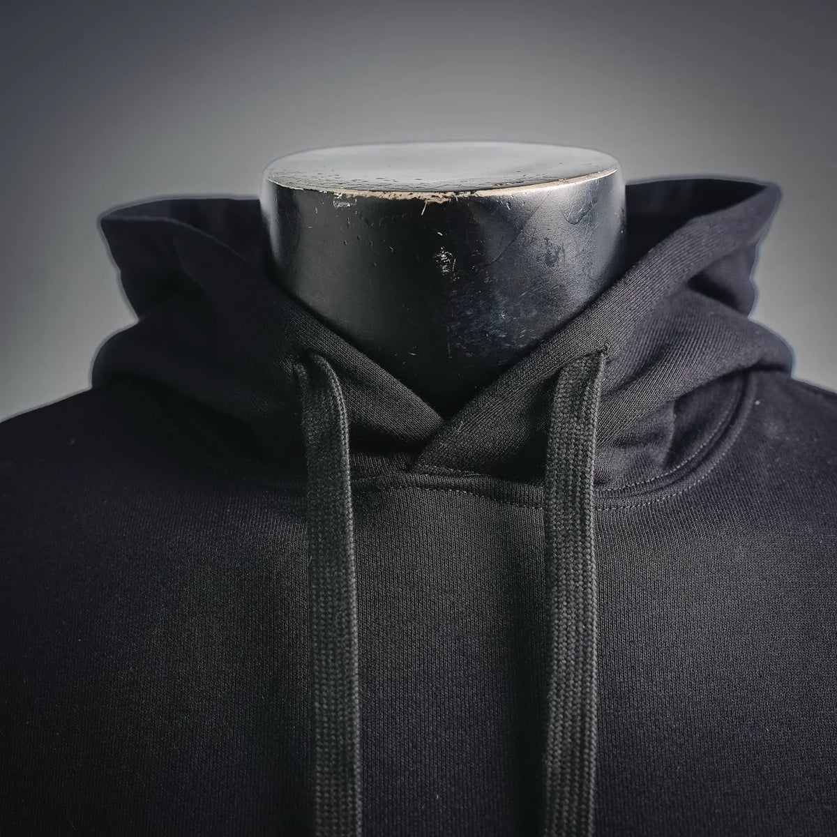Black hoodie neckline with drawstring and ribbed hem on the front