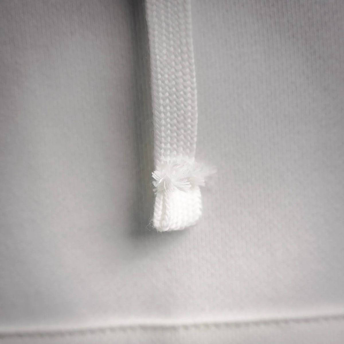 White hoodie drawstring end with tassel