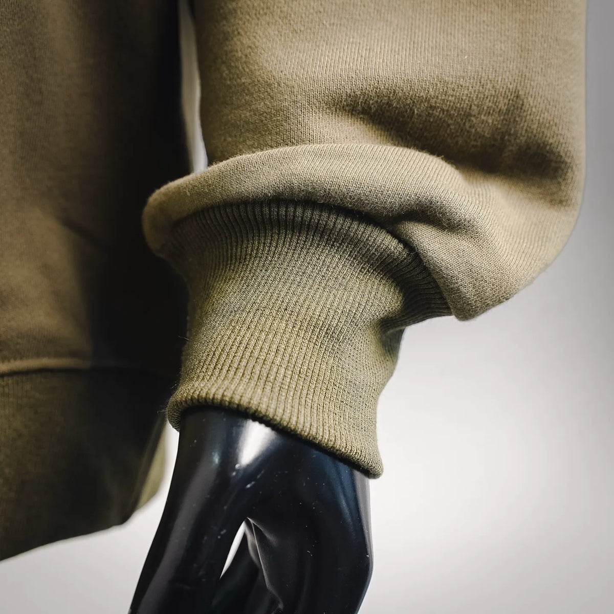 Olive sweatshirt sleeve cuff with ribbed knit hem detail