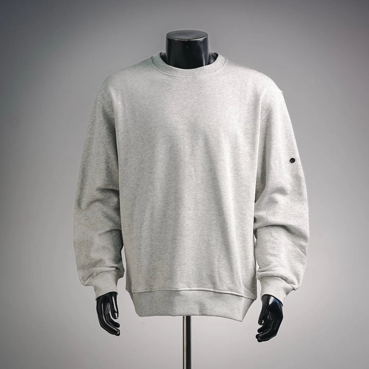 Light gray crewneck sweatshirt with ribbed hem and long sleeves