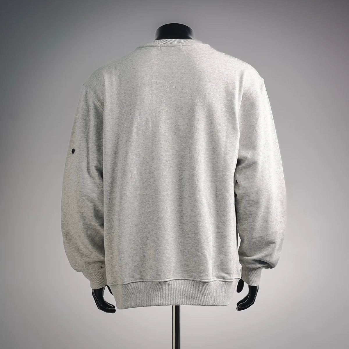 Light gray crewneck sweatshirt, back view with ribbed cuffs and hem