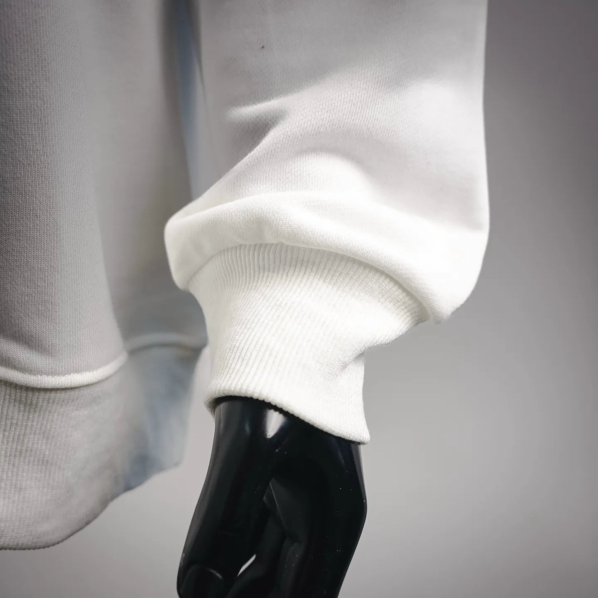 White Stone Island sweatshirt sleeve and ribbed cuff close-up