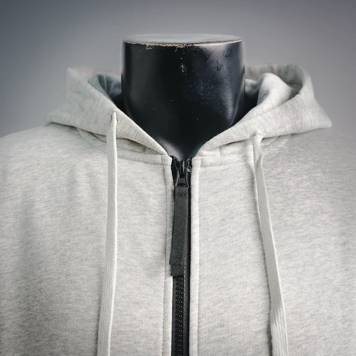 Light gray zip-up hoodie close-up of hood and front zipper