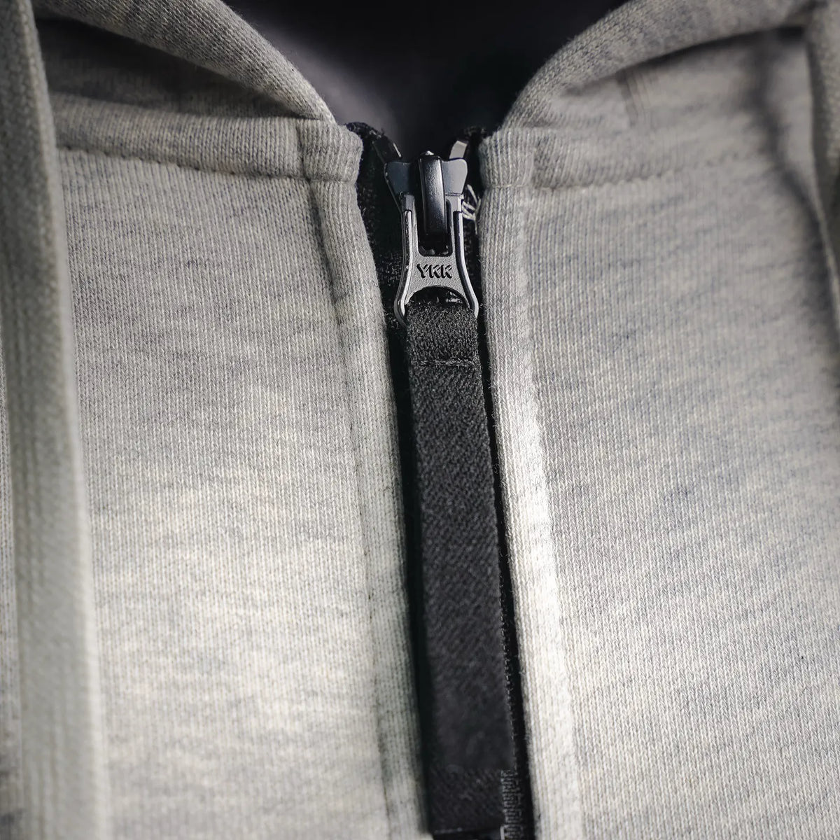 YKK front zipper detail on light gray zip hoodie