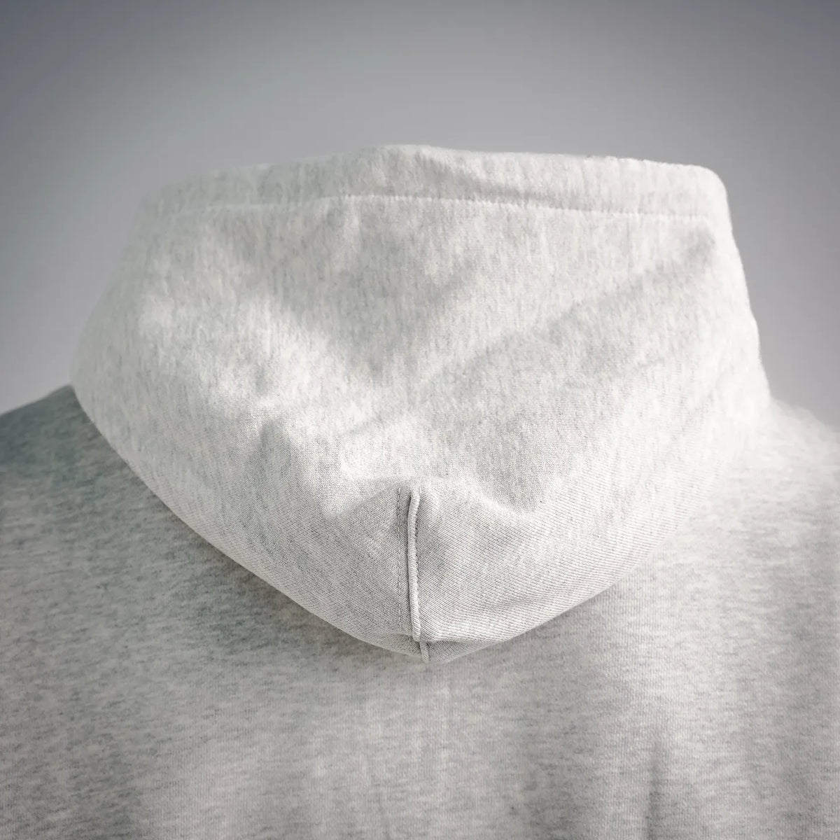Light gray zip hoodie back view with hood; ribbed hem