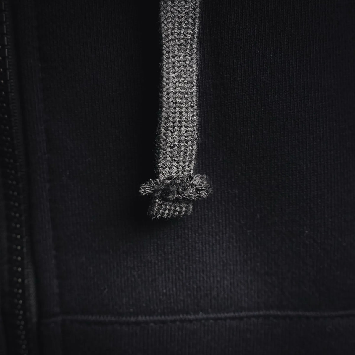 Black hoodie drawstring with textured aglet ends