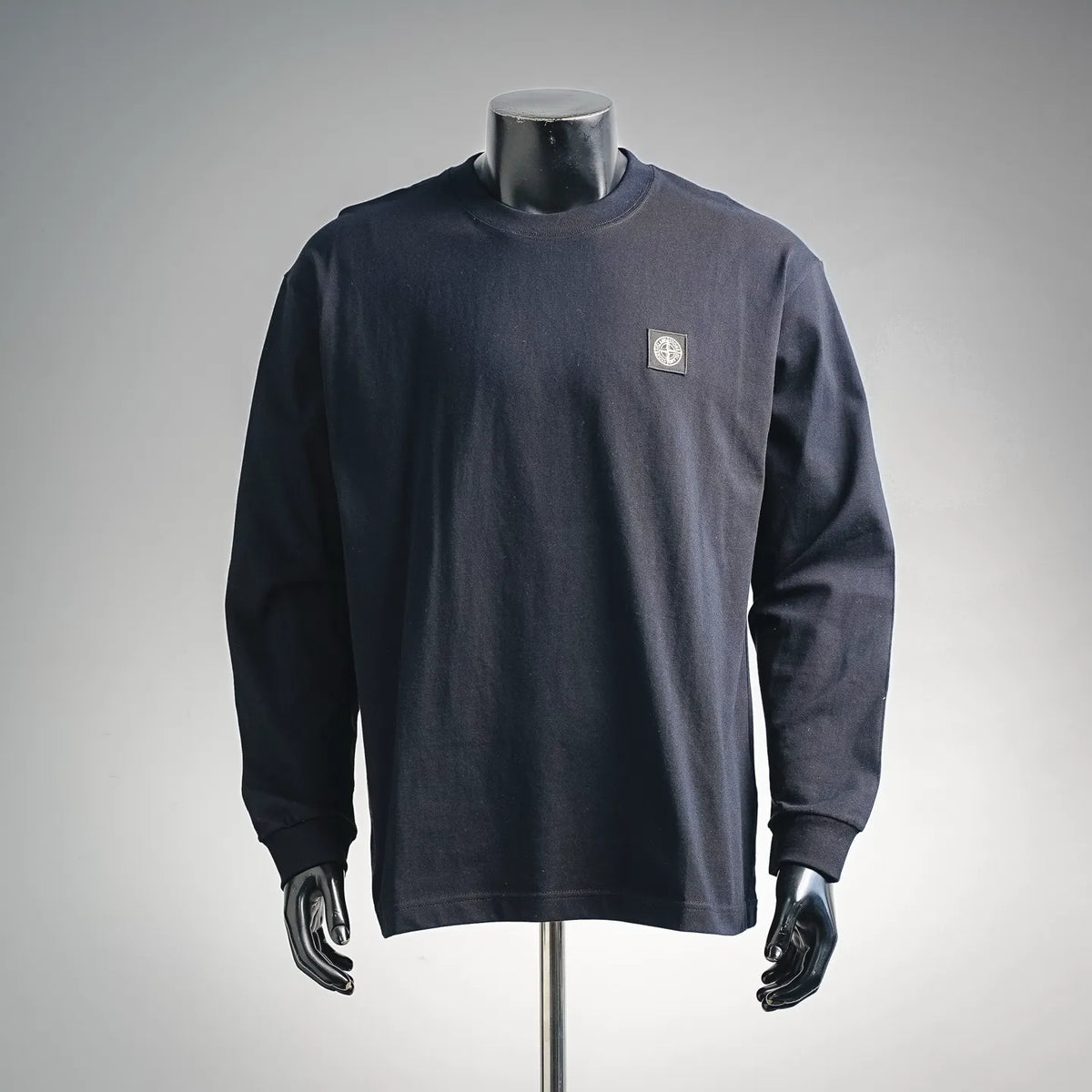 Navy long-sleeve crewneck sweatshirt with Stone Island badge on left chest