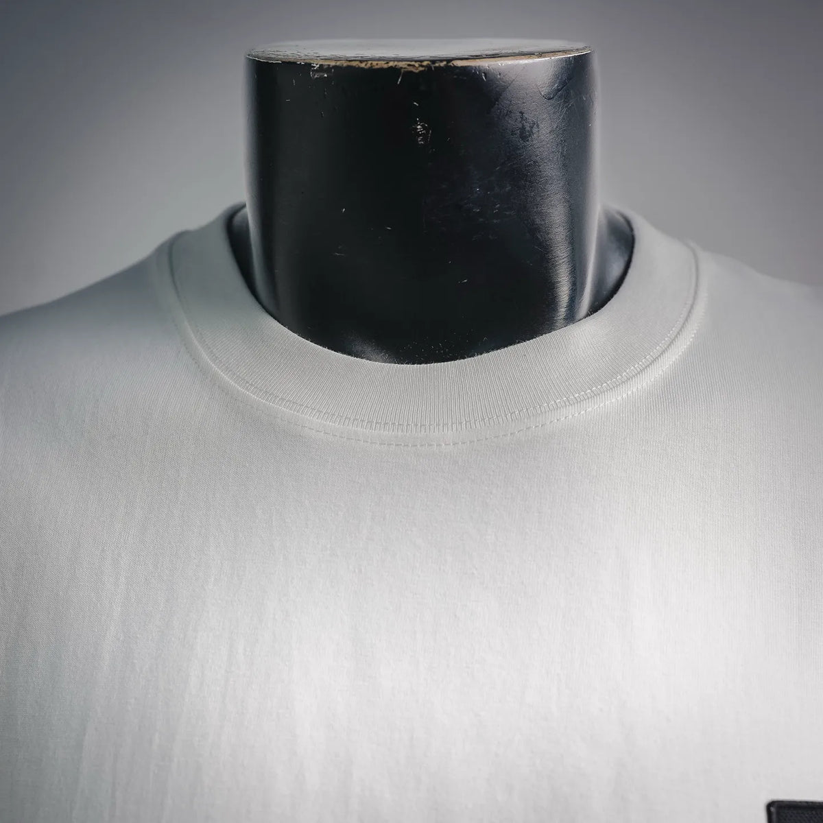 White crewneck collar of long-sleeve T-shirt with ribbed neckline