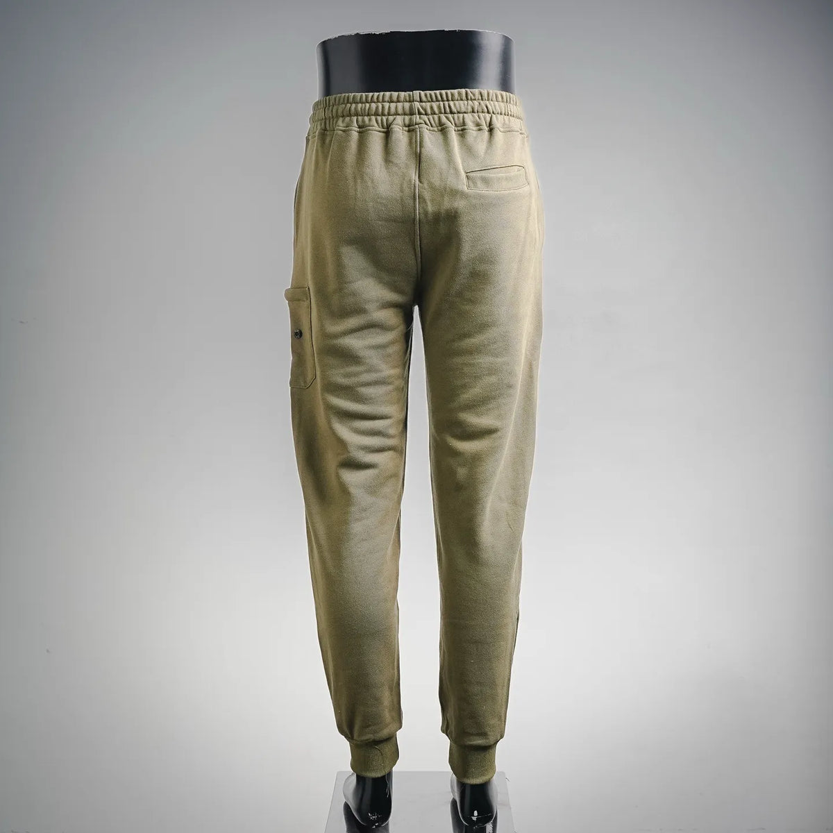 Olive jogger pants with elastic waistband and tapered legs, back view