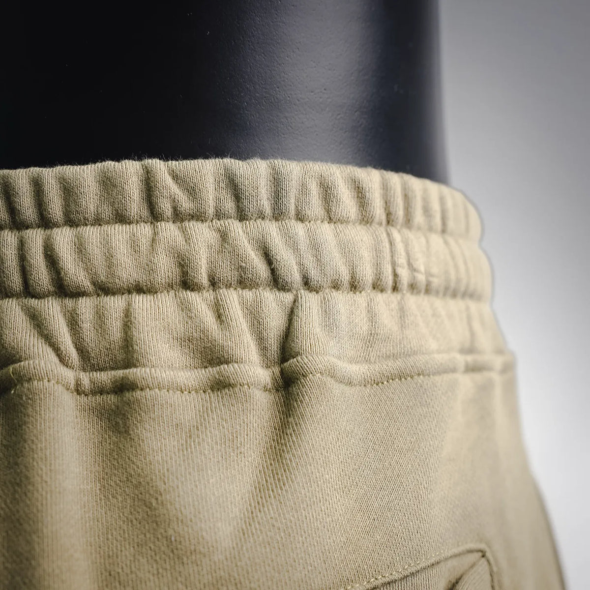 Olive jogger pants elastic waistband with gathered fabric texture