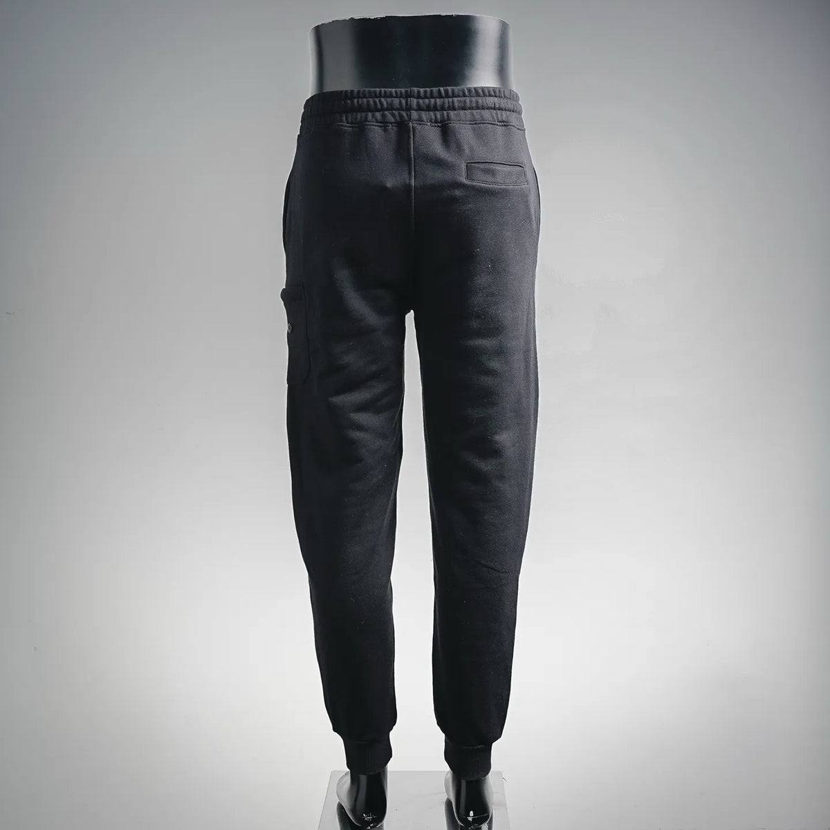Stone Island black jogger pants, back view, elastic waist and cuffed legs