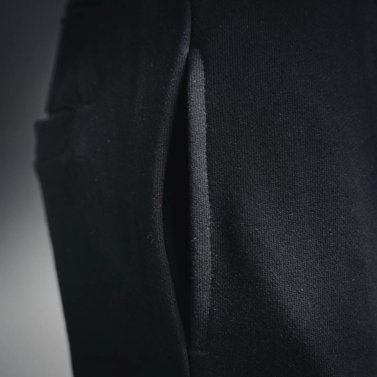 Stone Island black pants side view with visible seam and tapered leg