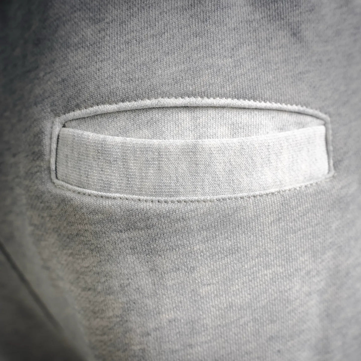 Light gray elastic waistband with interior label patch close-up.