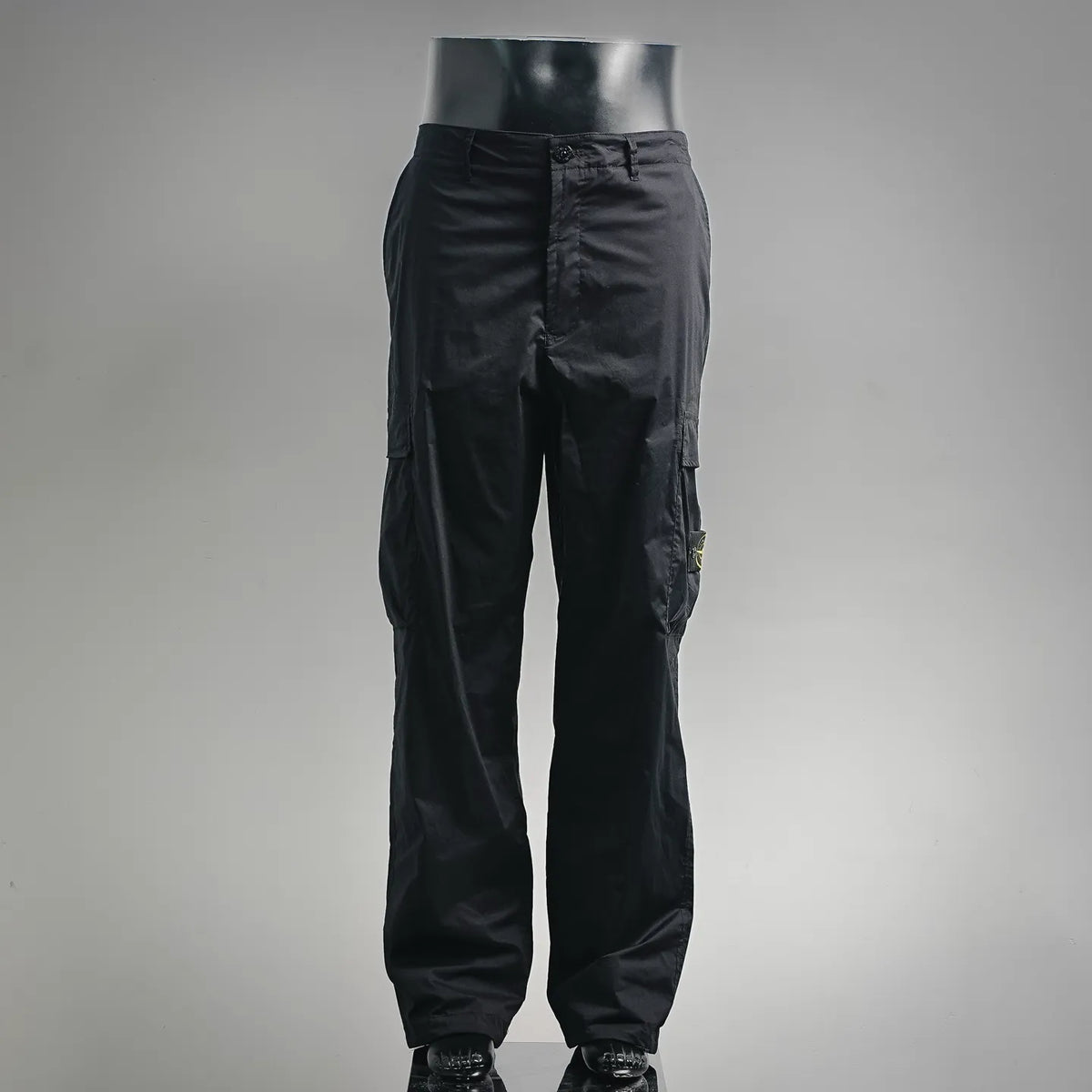 Black pants with cargo-style side pockets and tapered leg opening