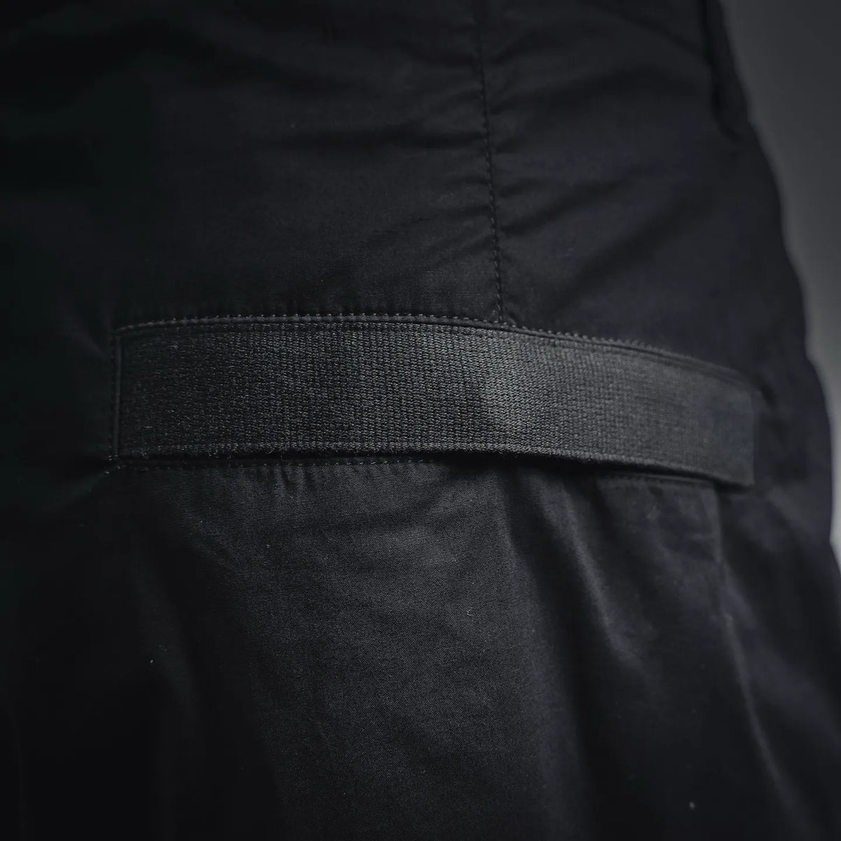 Black pants with ribbed waistband trim and smooth front panel