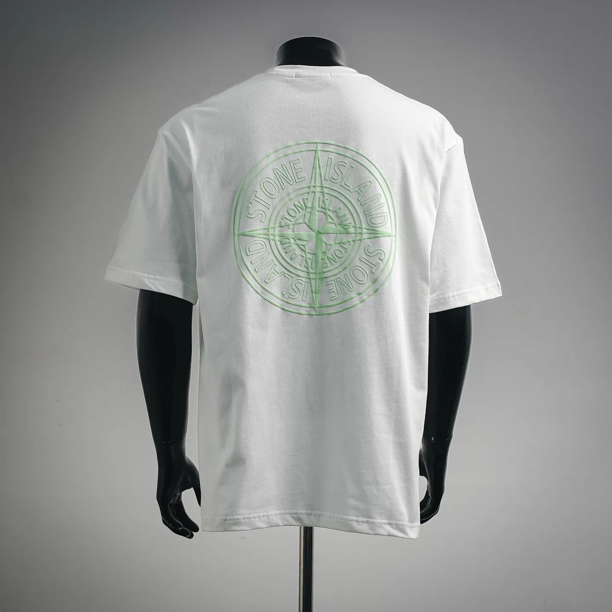 White T-shirt with green Stone Island circular logo on the back