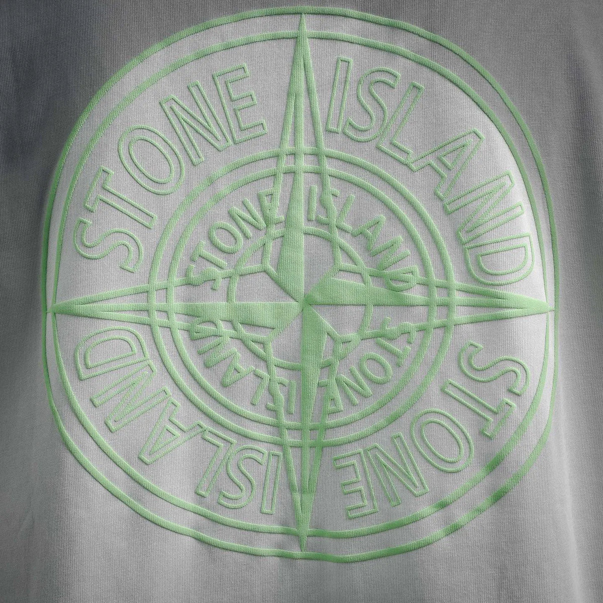Back graphic print with green Stone Island circular logo and compass star