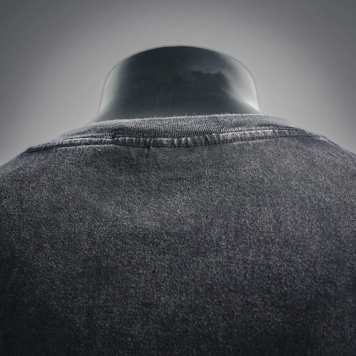 Stone Island T-shirt collar seam close-up, black crew neck with ribbed neckline