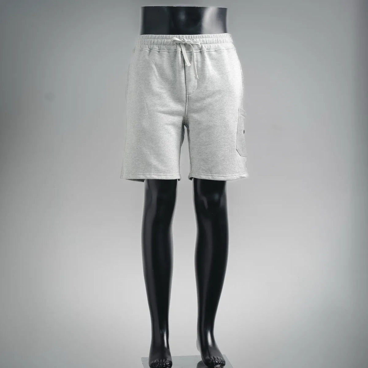 Light gray drawstring shorts on mannequin, elastic waistband and side pockets