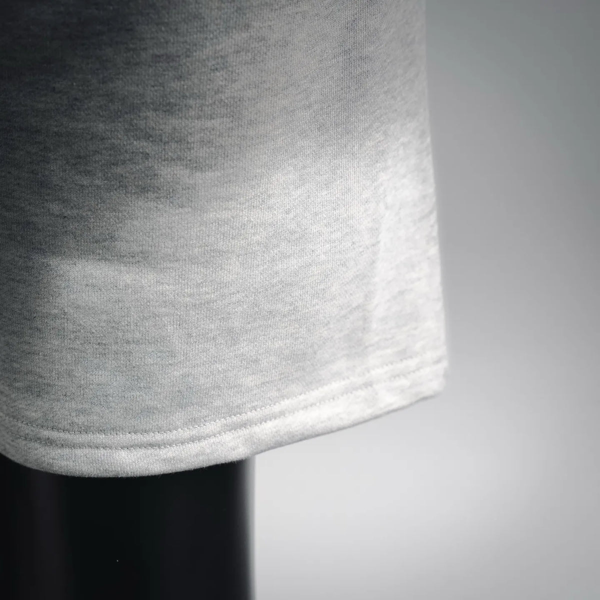 Light gray shorts hem with soft knit texture and stitched cuff