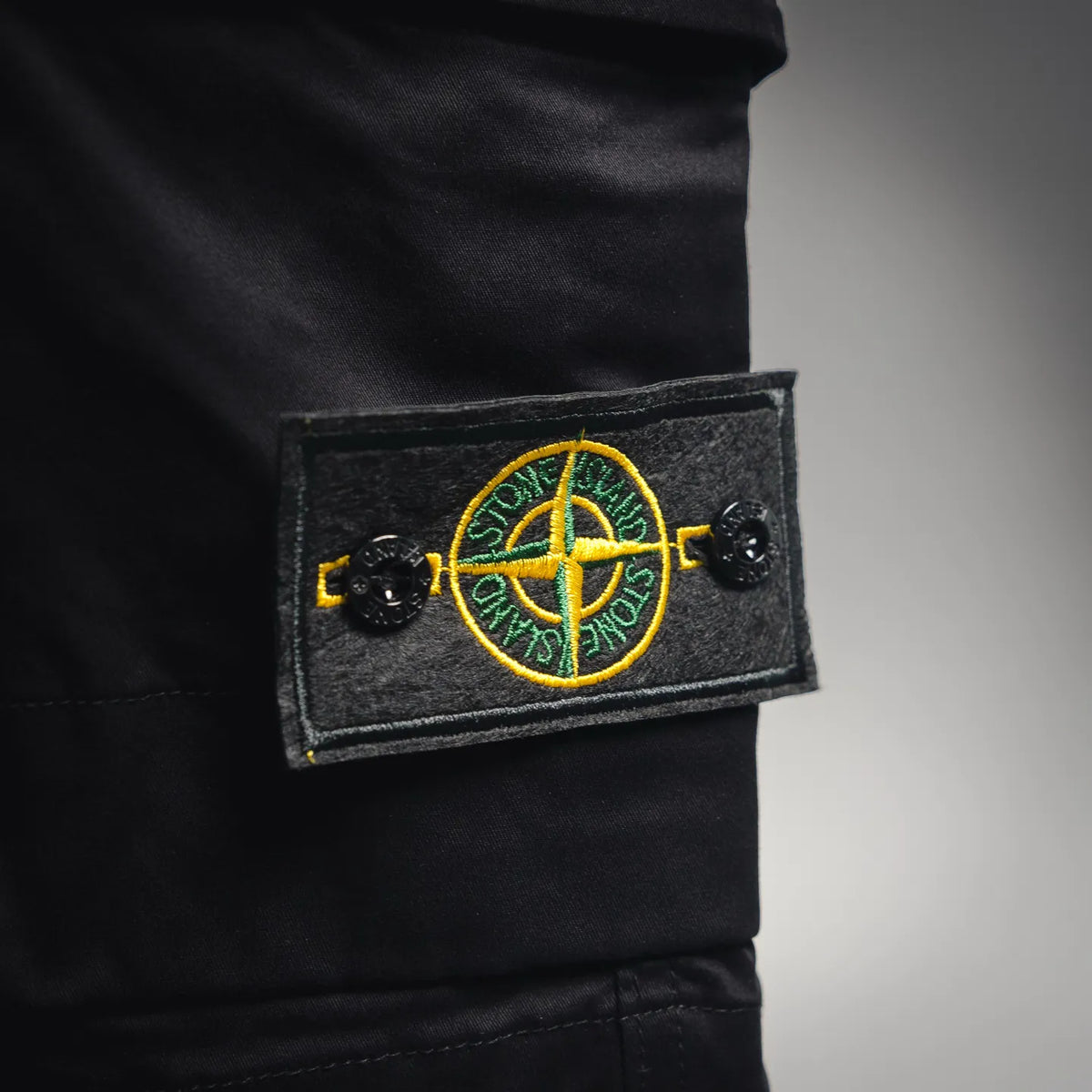 Stone Island black shorts with Compass logo patch on pocket