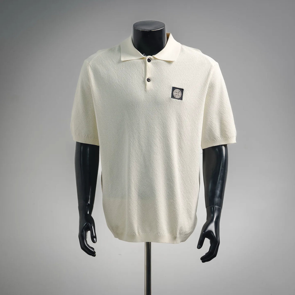 Stone Island short-sleeve polo shirt, off-white textured knit with chest logo patch.