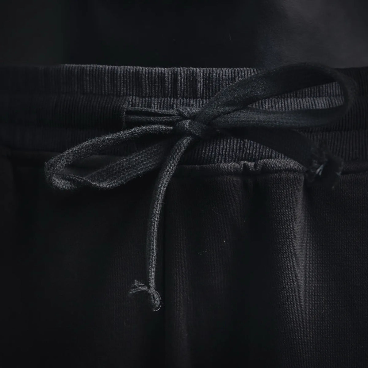 Black Stone Island pants drawstring and ribbed waistband detail