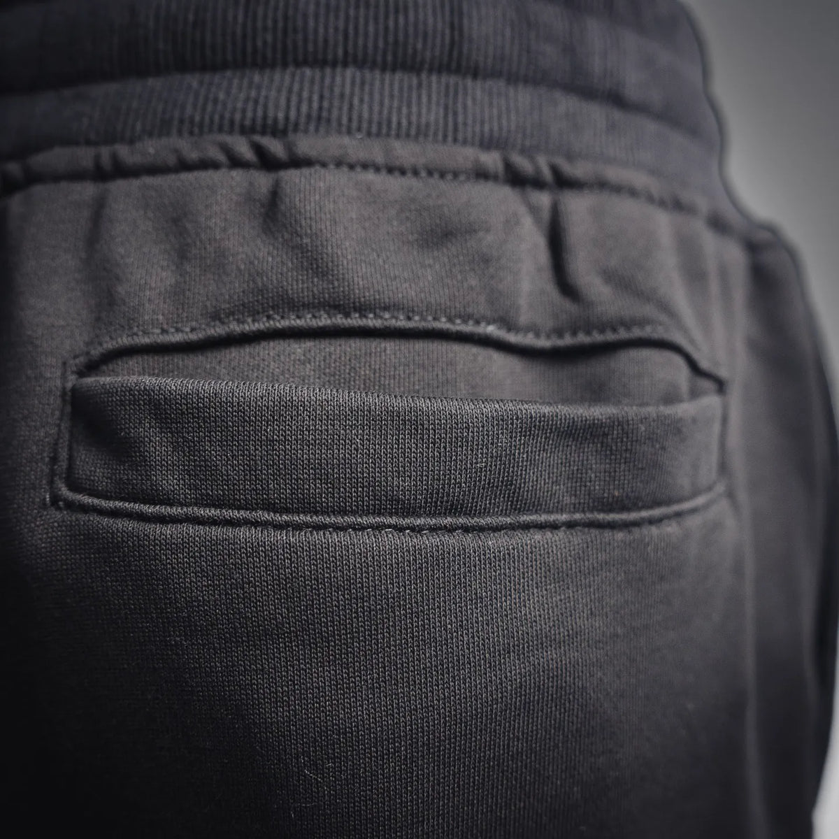 Black Stone Island pants front welt pocket and elastic waistband