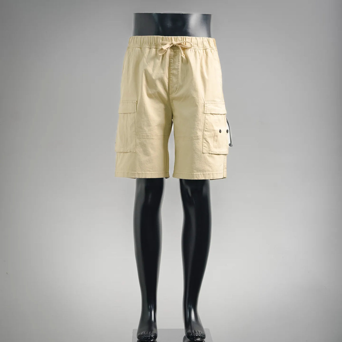 Beige drawstring cargo shorts with side pockets and buttoned flap detail