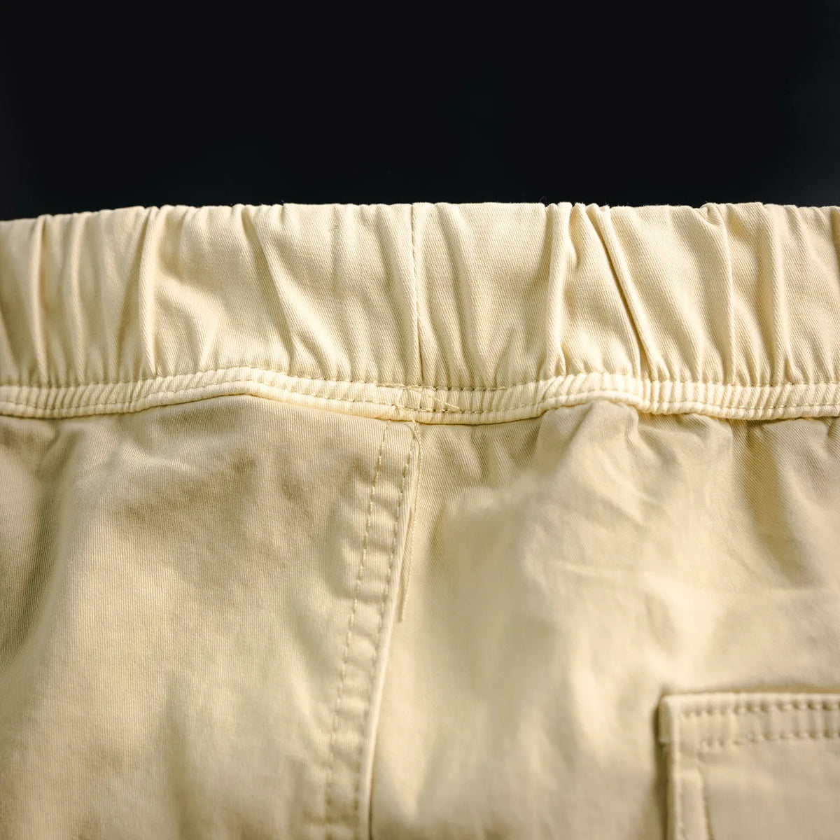 Beige elastic waistband with stitched panel detail on shorts