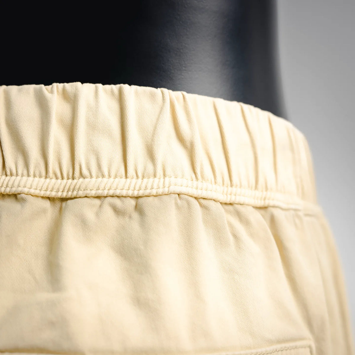 Beige shorts waistband with elastic gather and smooth stitched finish