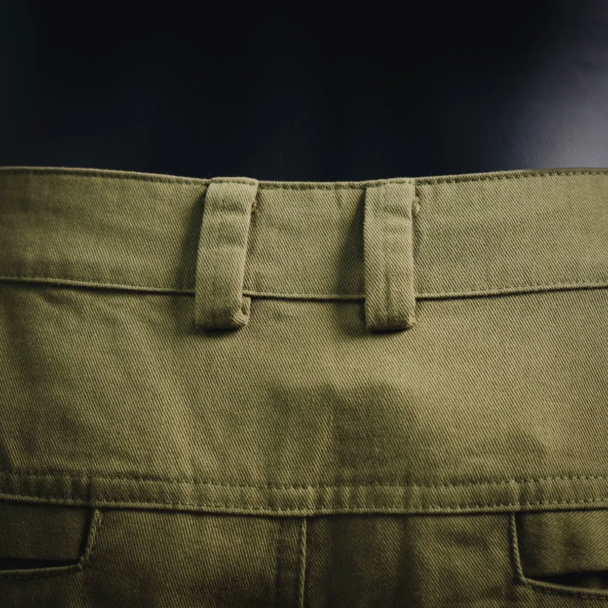 Olive shorts waistband with belt loops and buttoned center closure