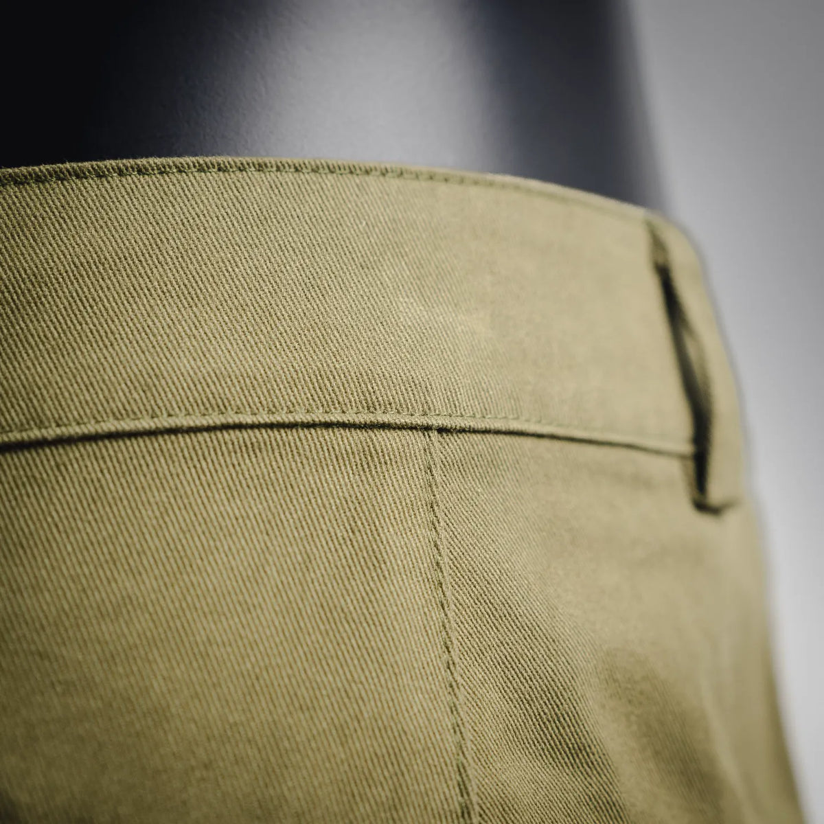 Olive shorts with back pocket panel and visible seam stitching