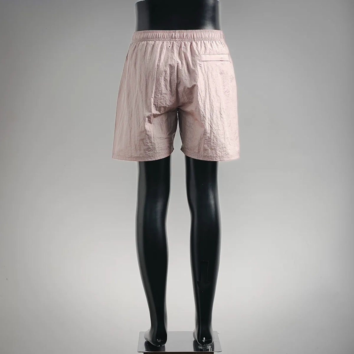 Light pink shorts with elastic waistband and relaxed fit; front view