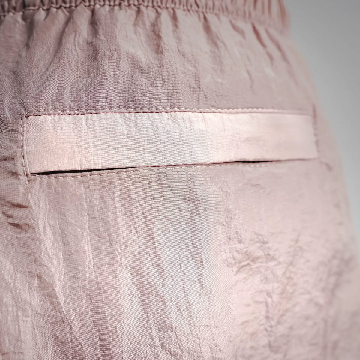 Light pink shorts with front button placket and stitched contrast edge