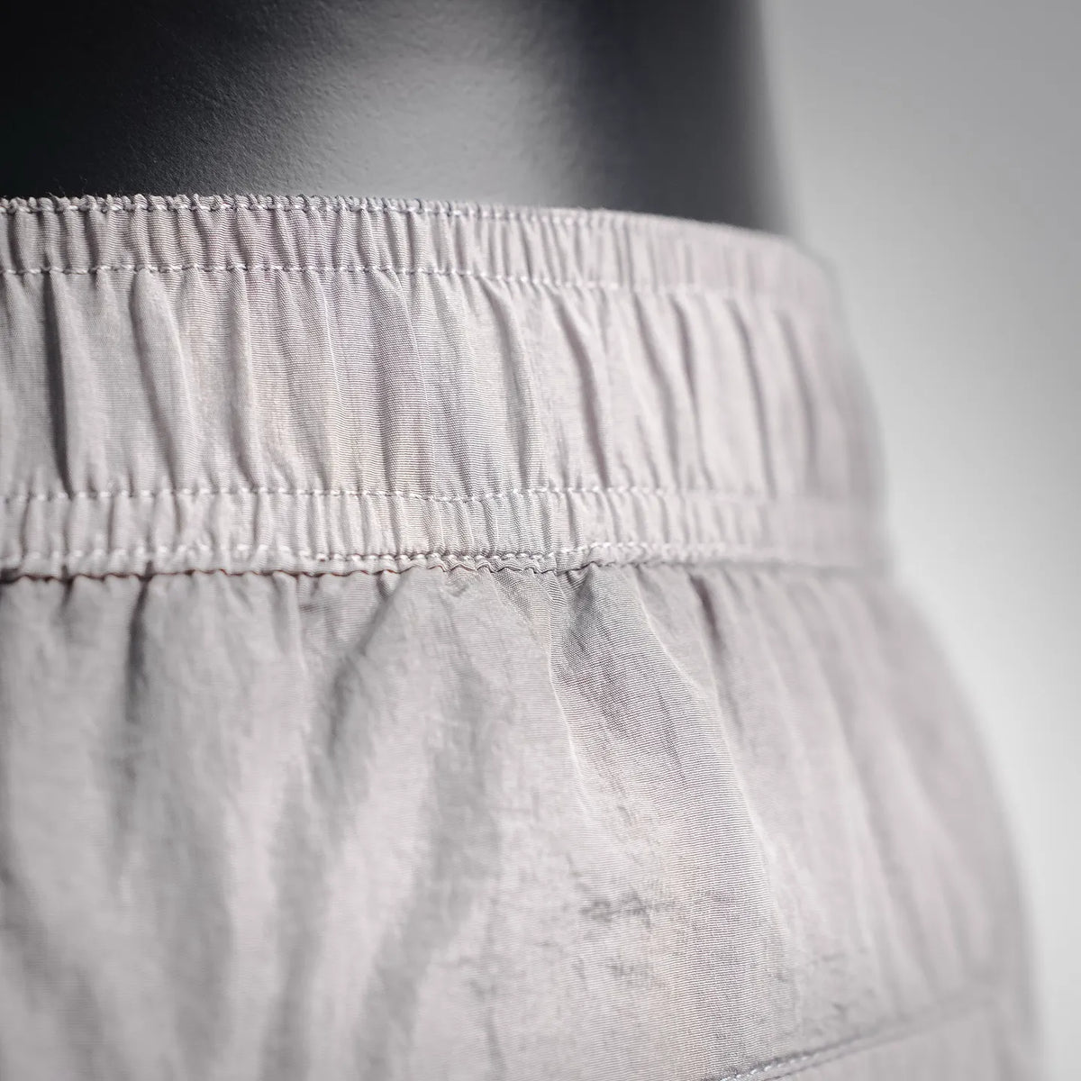 Stone Island light gray shorts waistband with gathered elastic and stitched seam