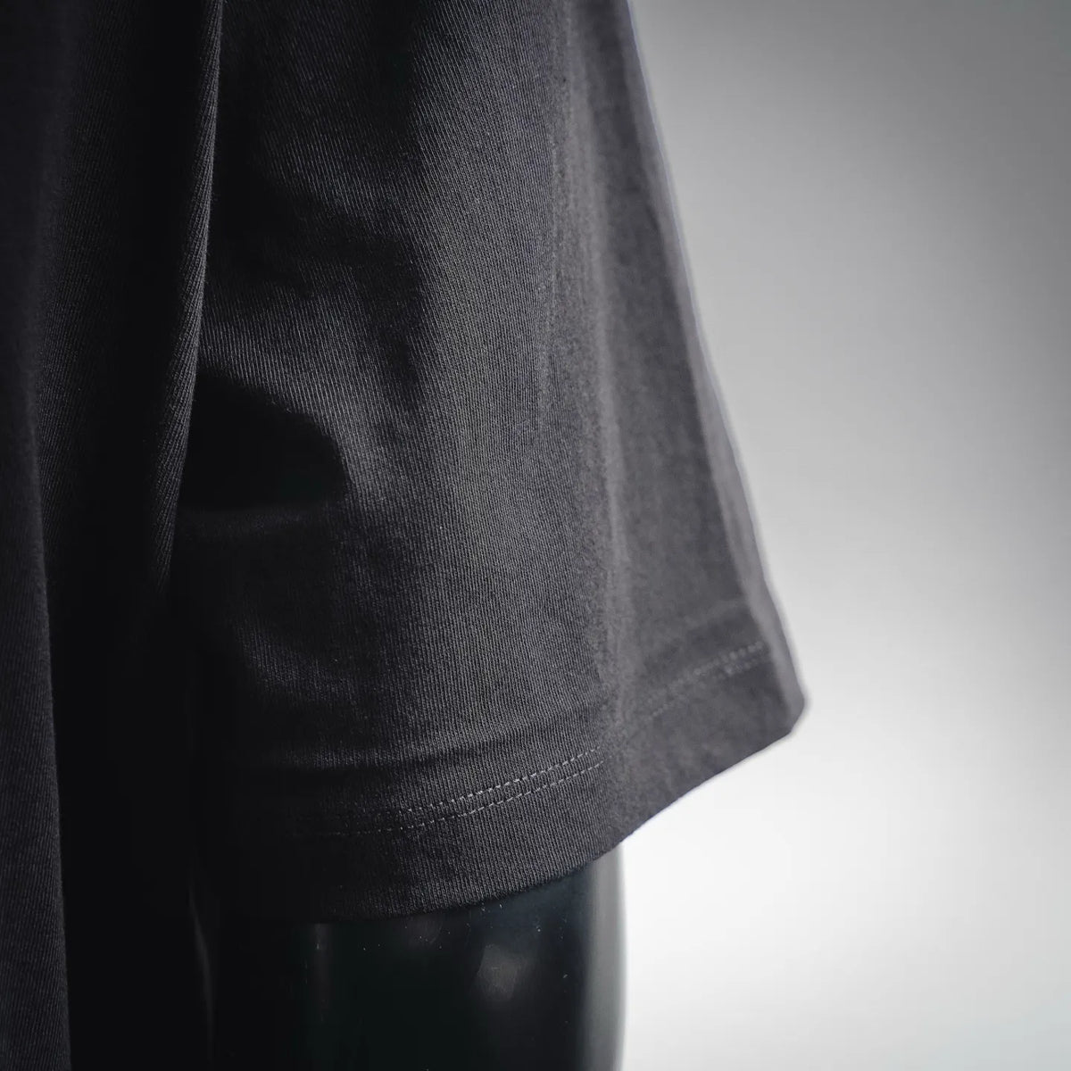 Men's black Stone Island T-shirt hem stitching close-up