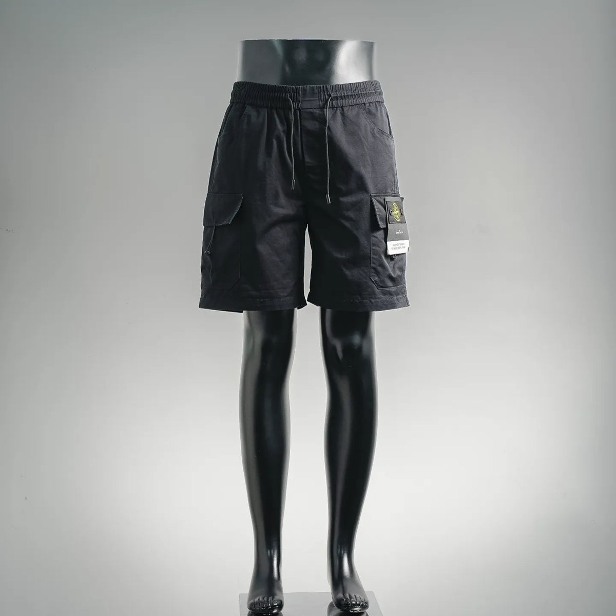 Black cargo shorts with elastic waistband and side utility pockets