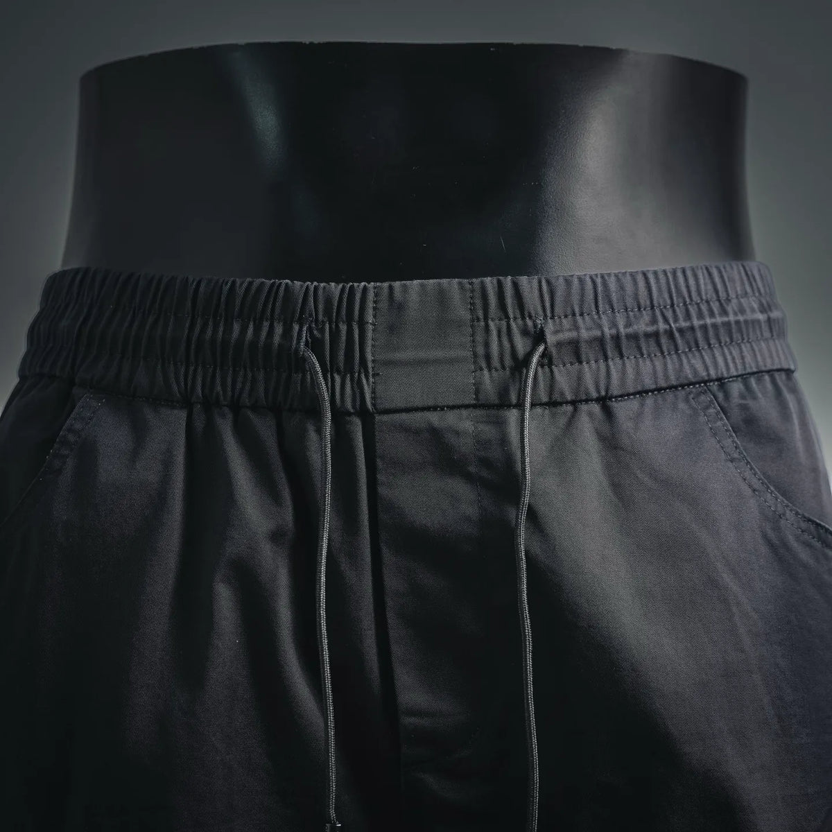 Black elastic-waist shorts with stitched drawcord seam