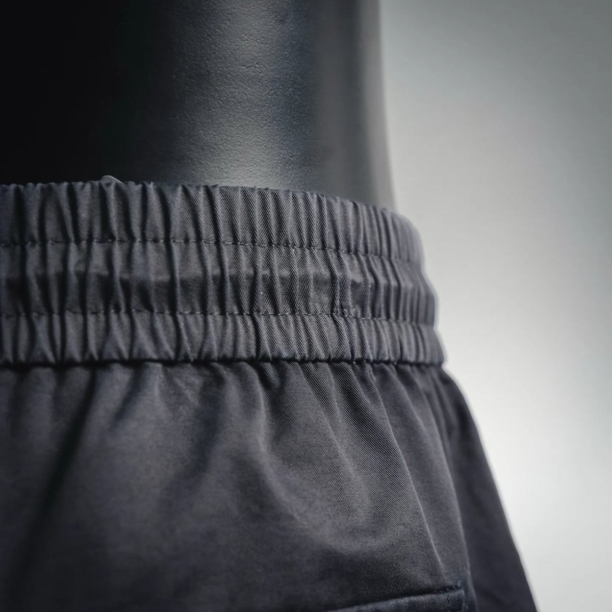 Black shorts waistband with elastic and gathered stitching detail